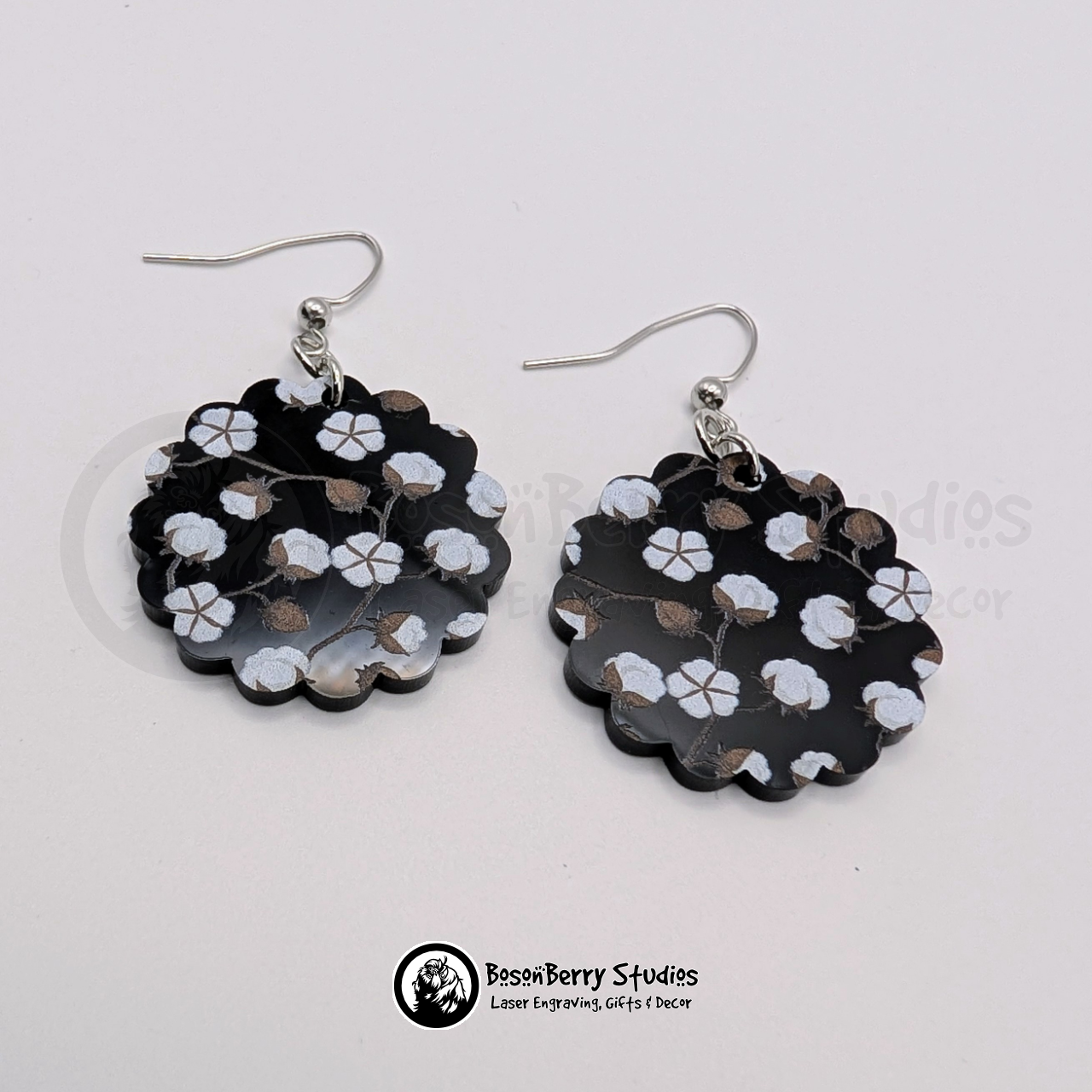 Black acrylic earrings with a cotton pattern, scalloped shaped, on a white background with 'BosonBerry Studios' branding.