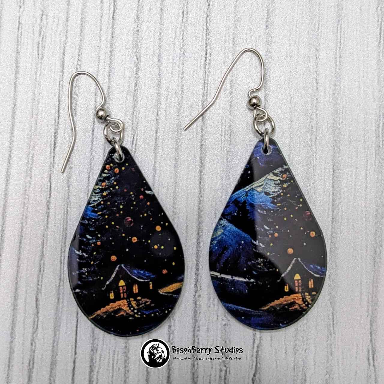 Teardrop shaped Starry Swirl Christmas Acrylic Earrings on white background.