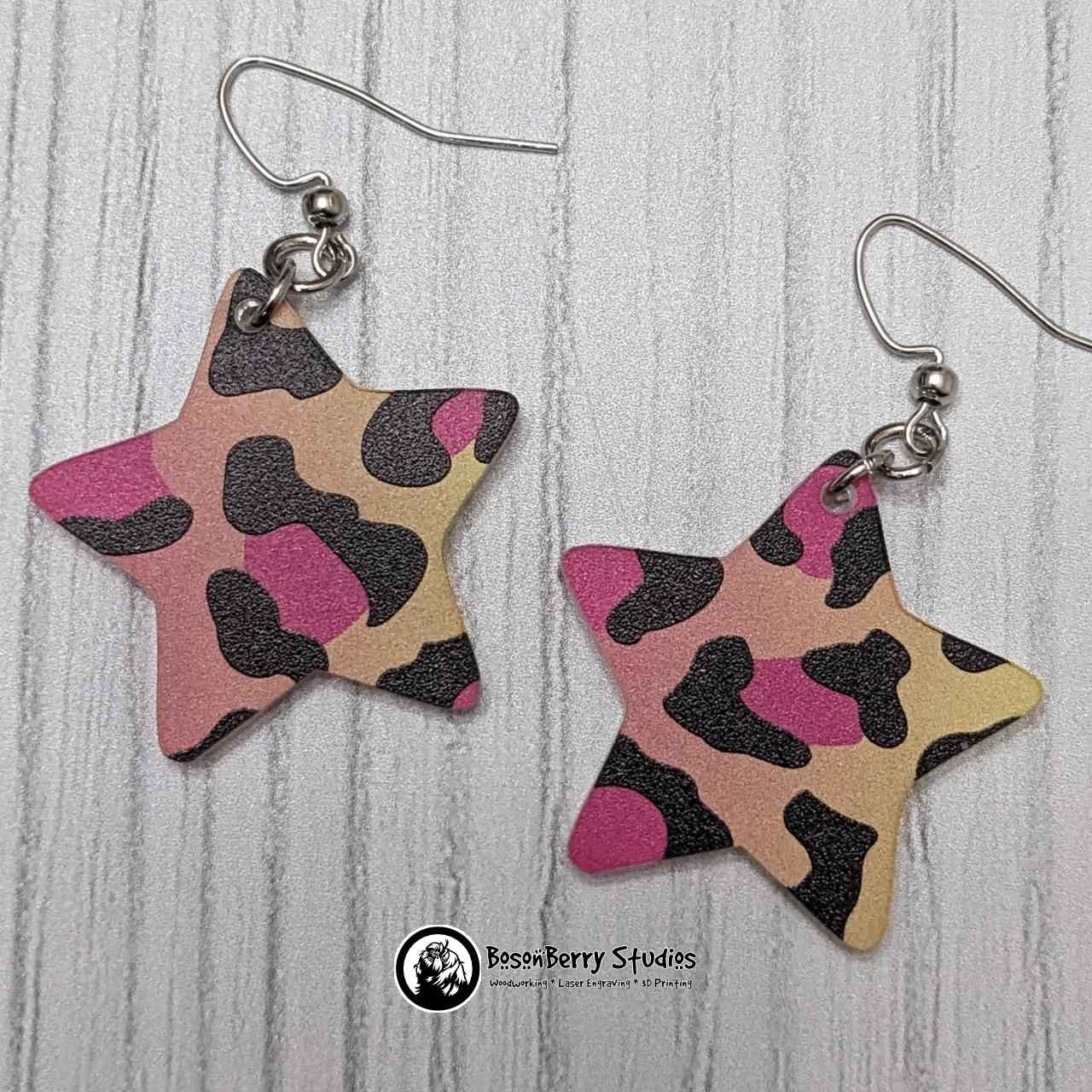 Star shaped Rainbow Cheetah Acrylic Earrings on white background.