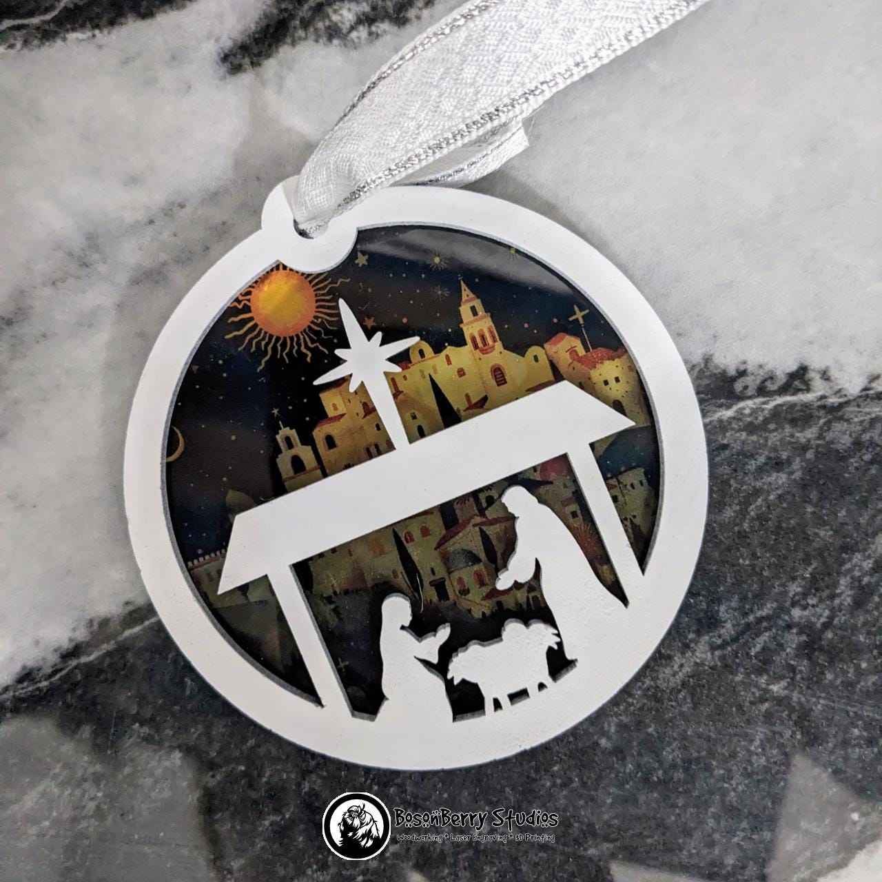 Bethlehem Nativity Christmas Ornament with transparent backer on marble background
