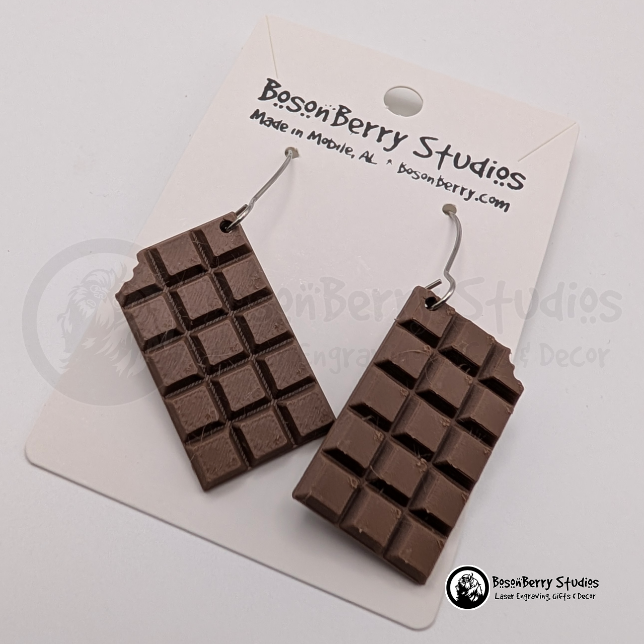 Set of brown chocolate bar-shaped earrings on cards with 'BosonBerry Studios' branding.
