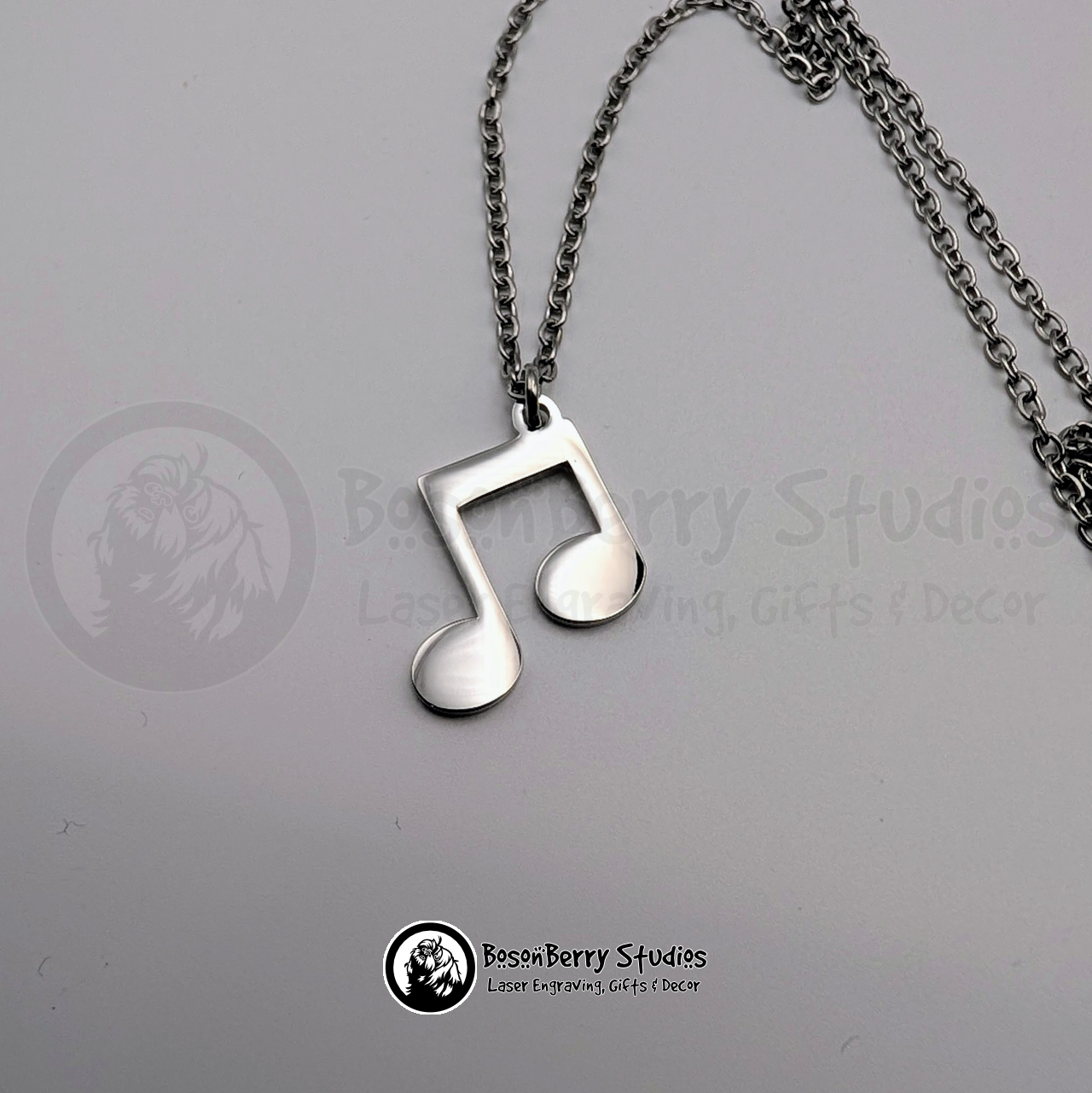 Silver music note pendant on a white background with 'BosonBerry Studios' branding.