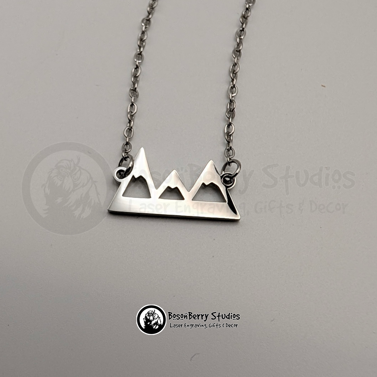 Silver mountain pendant necklace on a white background with 'BosonBerry Studios' branding.