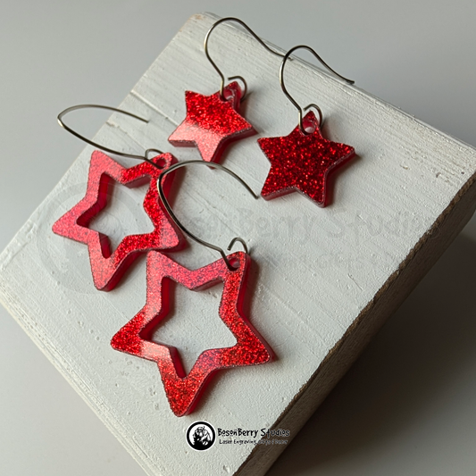Star-shaped red glitter earrings on a white background, branded 'BosonBerry Studios'.