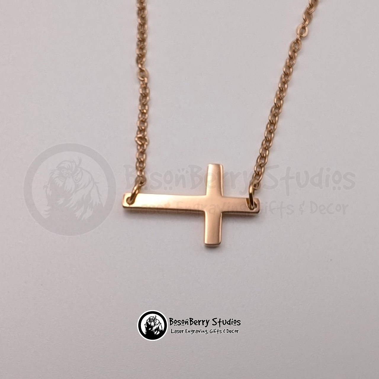 Rose Gold tiny cross necklace on a white background with 'BosonBerry Studios' branding.