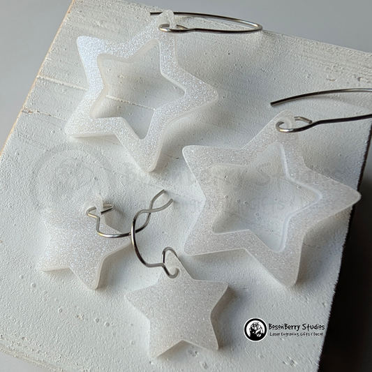 Star-shaped white glitter earrings on a white background, branded 'BosonBerry Studios'.