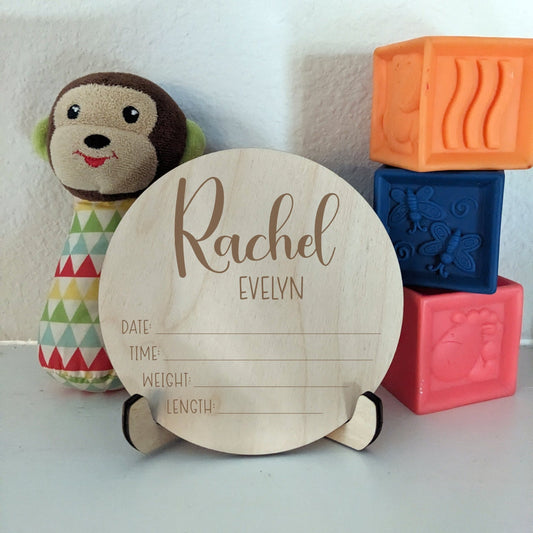A sign for newborn stats with toys in the background
