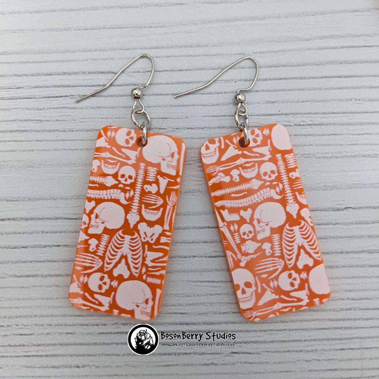Acrylic "Scattered Bones on Orange" Earrings | Halloween Spooky Fun Fall | Skull Bone Cat Bat Pumpkin Shapes | Laser Cut
